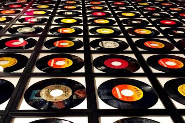 Vinyl records on a wall with camera angle rotates by 90 degrees