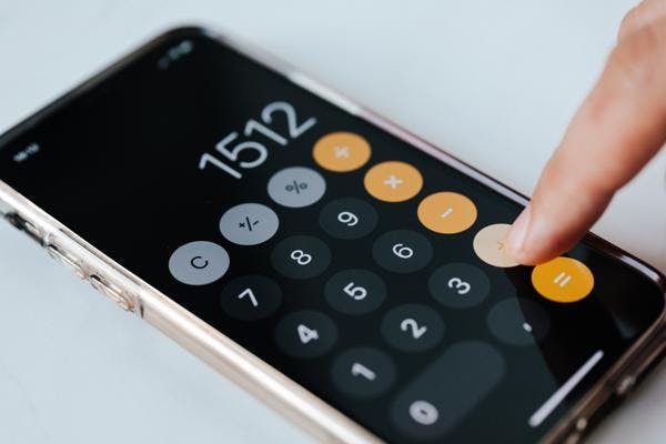 Person using calculator on phone for percentage