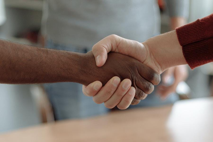 Two people shaking hands after negotiation