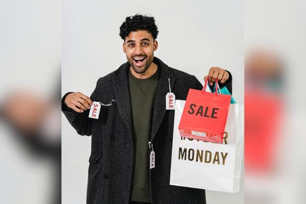Man with shopping bags with items on sale