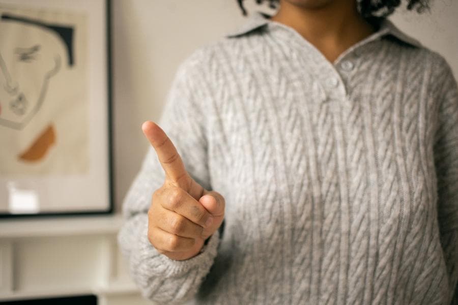 Person waving no with finger